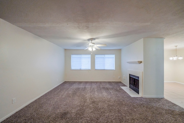 unfurnished living room featuring a textured ceiling, ceiling fan with notable chandelier, and light carpet