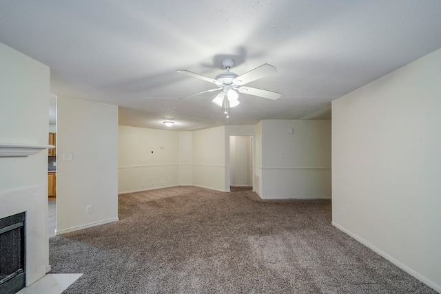 basement with ceiling fan and carpet floors