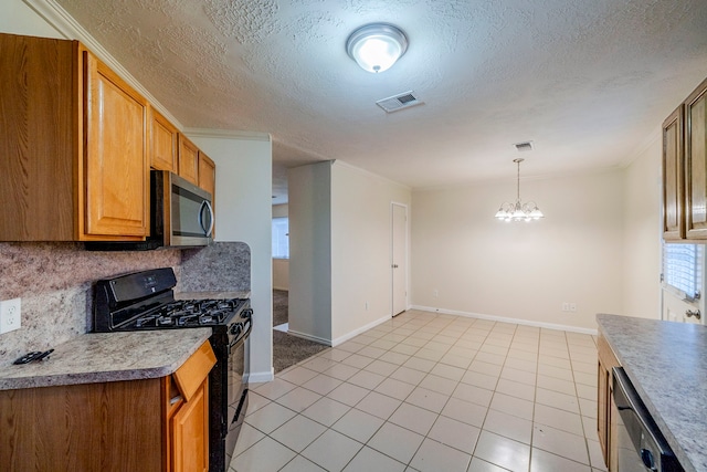 kitchen featuring a notable chandelier, hanging light fixtures, crown molding, and appliances with stainless steel finishes