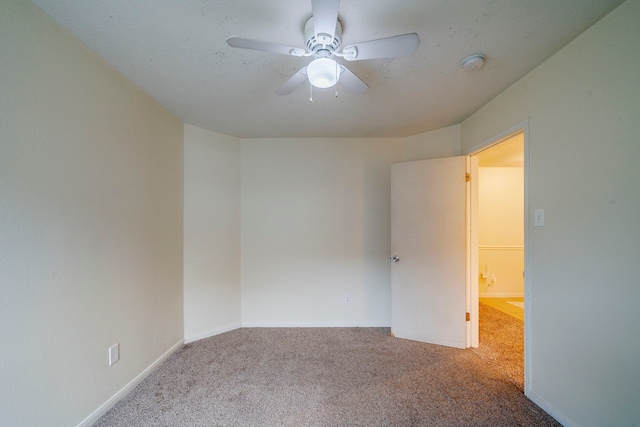 spare room featuring ceiling fan and light carpet