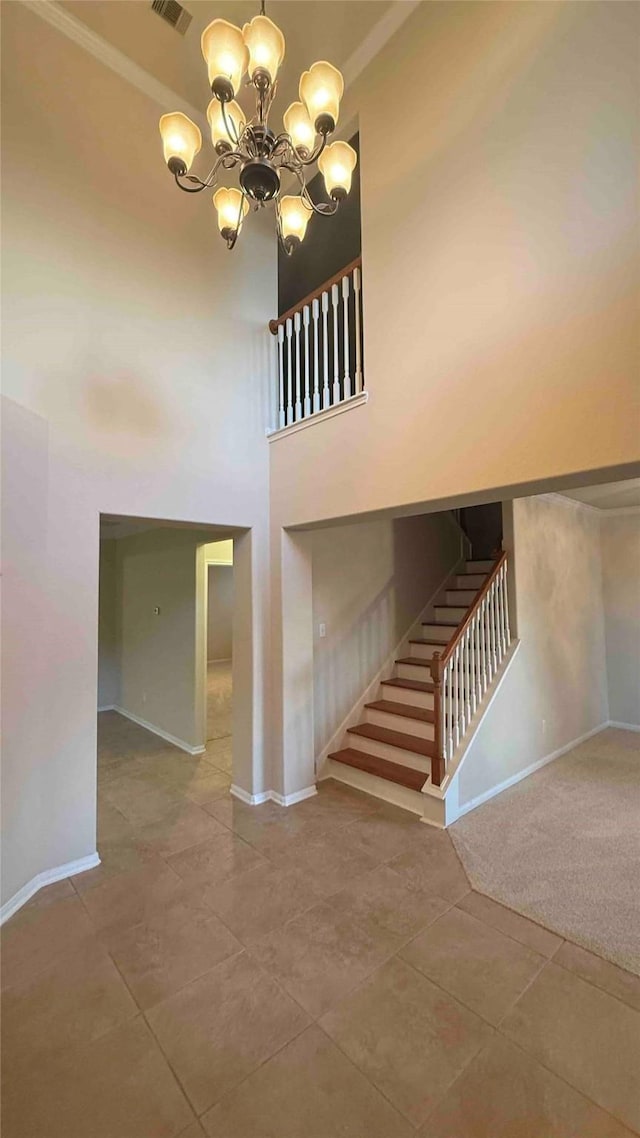 stairway featuring carpet flooring, a notable chandelier, and a high ceiling