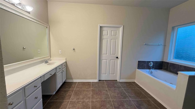 bathroom with a tub to relax in, tile patterned flooring, and vanity