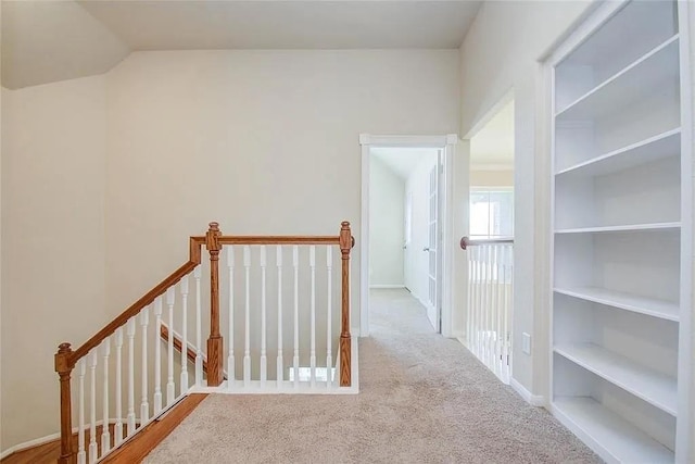 corridor featuring light colored carpet