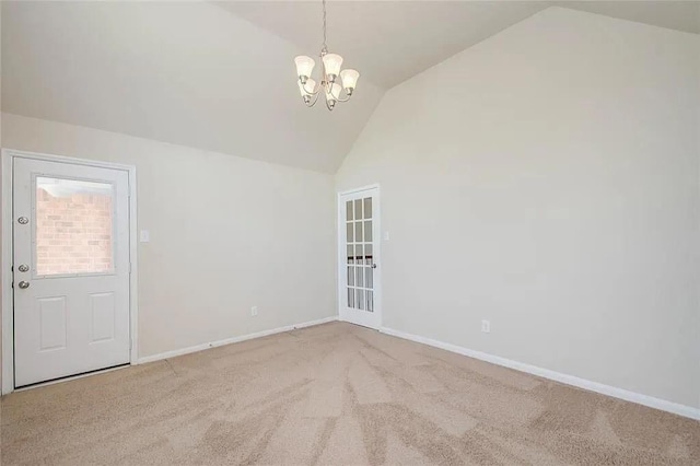 empty room with light colored carpet, vaulted ceiling, and a notable chandelier