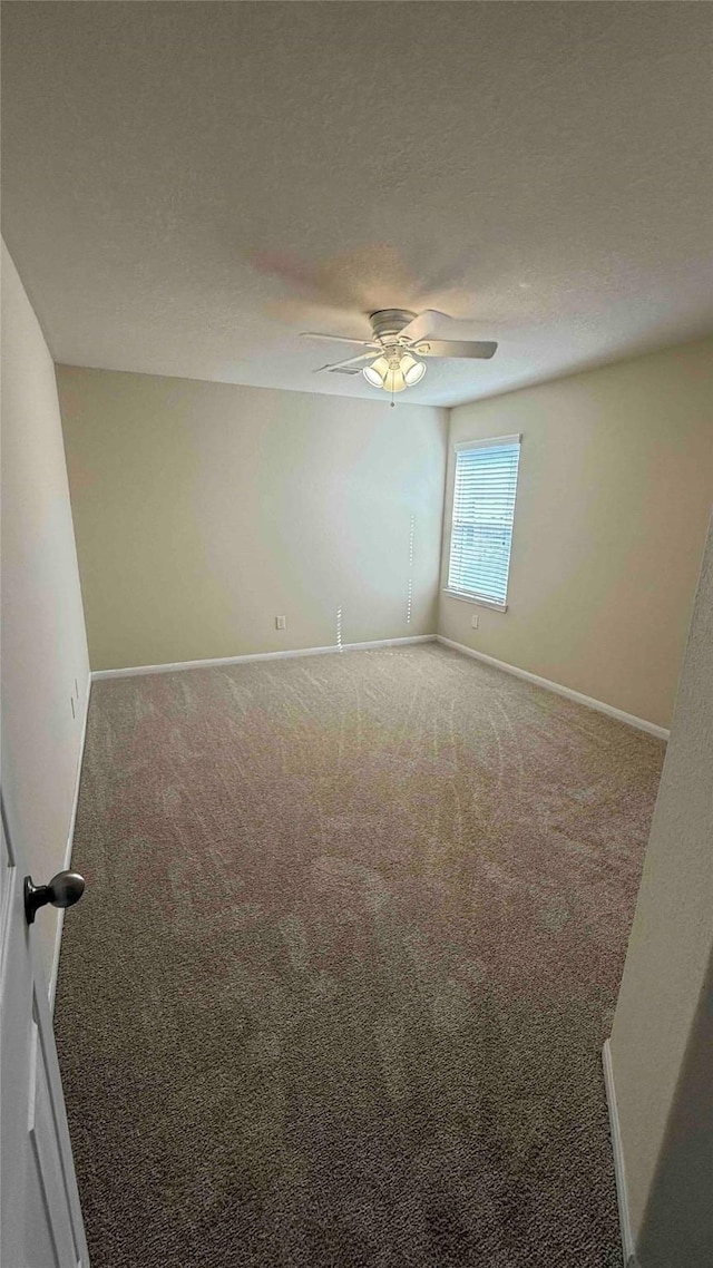 carpeted spare room featuring a textured ceiling