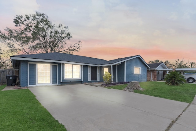 ranch-style home featuring a lawn