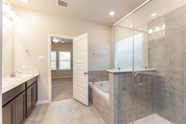 bathroom featuring tile patterned flooring, shower with separate bathtub, vanity, and ceiling fan