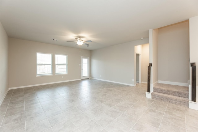 tiled empty room featuring ceiling fan