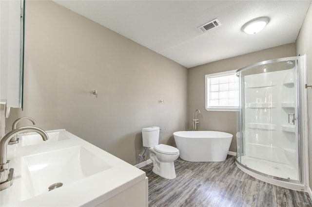 full bathroom featuring sink, hardwood / wood-style floors, independent shower and bath, and toilet