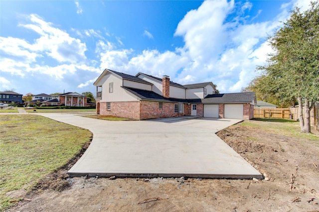 view of front of property featuring a garage and a front lawn