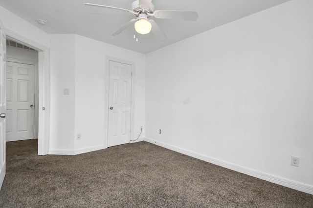 unfurnished bedroom with ceiling fan and dark carpet