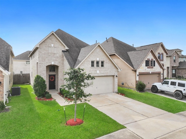 view of front of house featuring central AC unit, a front yard, and a garage