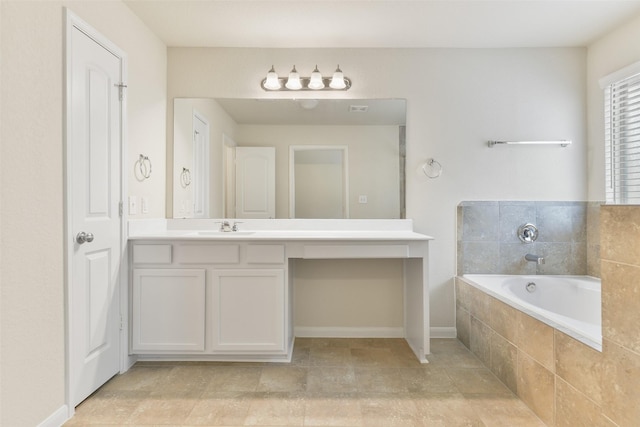 bathroom with vanity and tiled tub