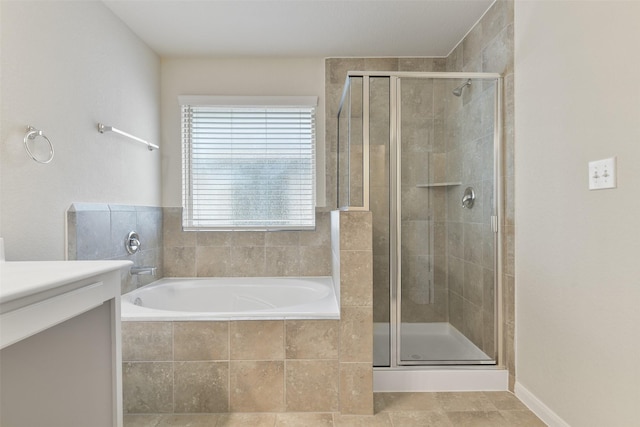 bathroom featuring vanity and separate shower and tub