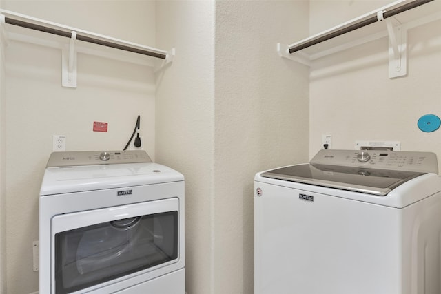 laundry area with washing machine and clothes dryer