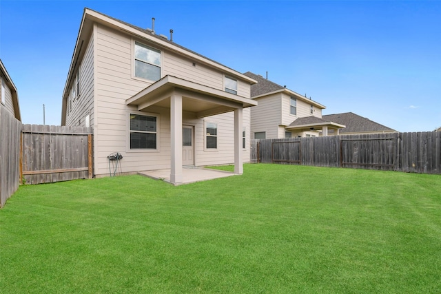 rear view of house with a patio and a yard