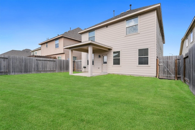 back of house featuring a patio and a yard