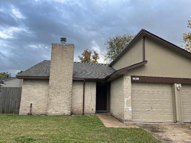 view of front of home with a front yard and a garage