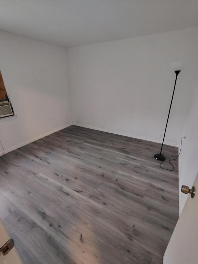 unfurnished room with hardwood / wood-style flooring