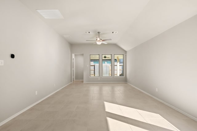 spare room featuring ceiling fan, light tile patterned floors, and lofted ceiling