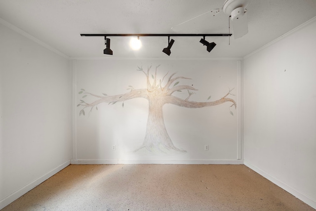 unfurnished room with crown molding and track lighting