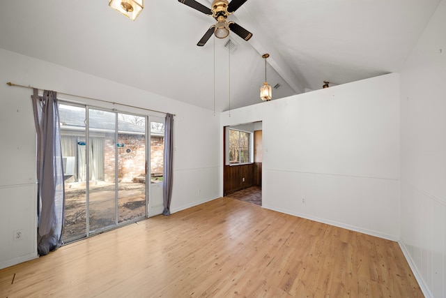 spare room featuring wood-type flooring, vaulted ceiling with beams, and ceiling fan