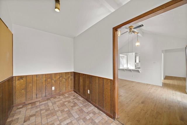 unfurnished room with lofted ceiling with beams and ceiling fan