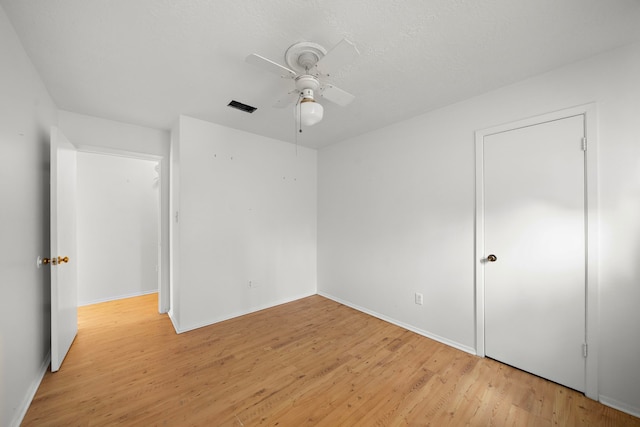 empty room with ceiling fan and light wood-type flooring