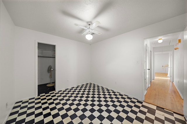 unfurnished room featuring a textured ceiling and ceiling fan