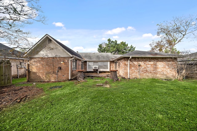 rear view of house with a yard