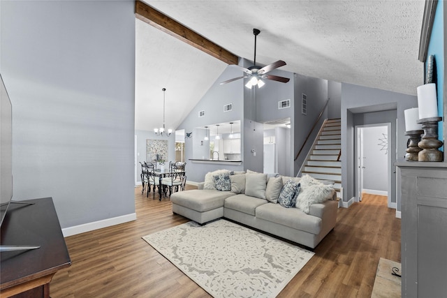 living room featuring beam ceiling, high vaulted ceiling, hardwood / wood-style floors, a textured ceiling, and ceiling fan with notable chandelier