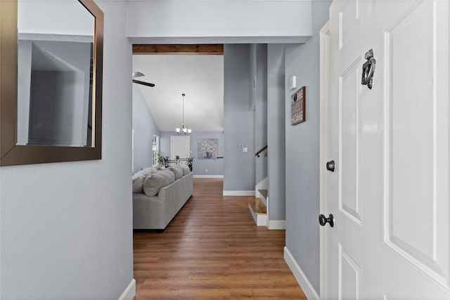 hallway featuring vaulted ceiling, a chandelier, and dark hardwood / wood-style floors