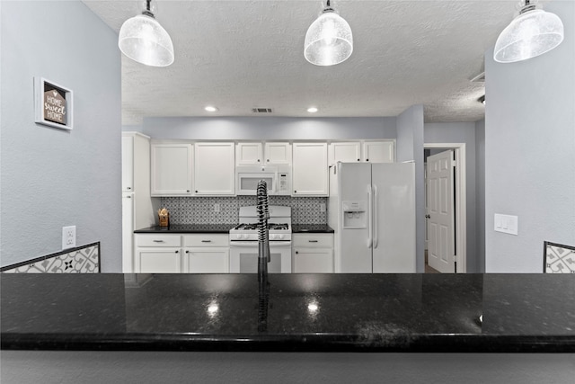 kitchen with white cabinets, pendant lighting, and white appliances