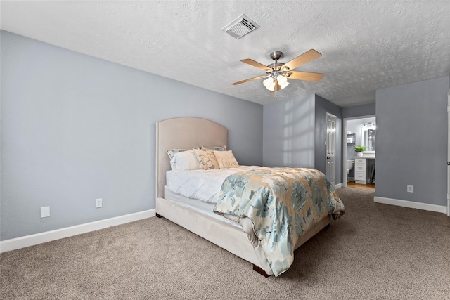 carpeted bedroom featuring a textured ceiling and ceiling fan