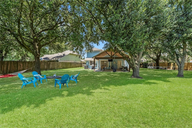 view of yard featuring a patio and a fire pit