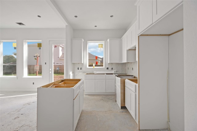 kitchen featuring a center island, white cabinetry, and tasteful backsplash