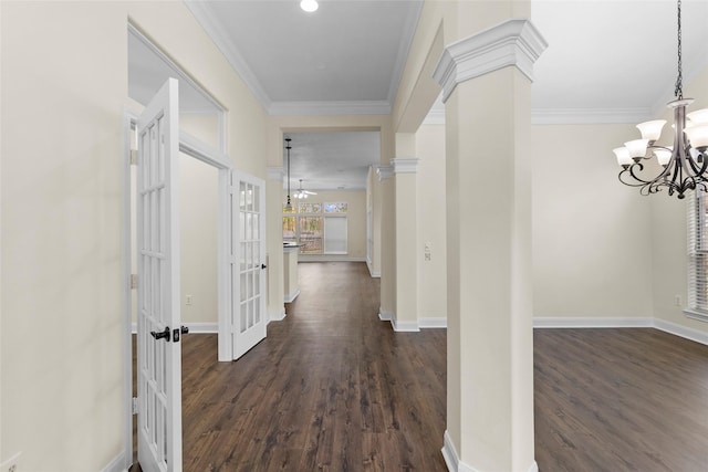 hallway with french doors, dark hardwood / wood-style flooring, decorative columns, and crown molding