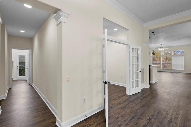 hallway with french doors, dark hardwood / wood-style flooring, decorative columns, and crown molding