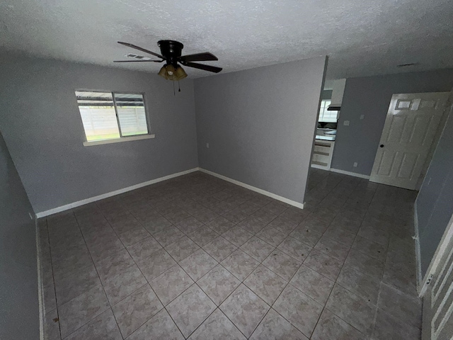 empty room featuring ceiling fan and a textured ceiling