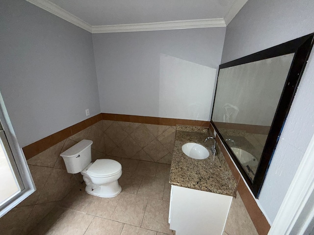 bathroom with vanity, toilet, tile walls, and crown molding