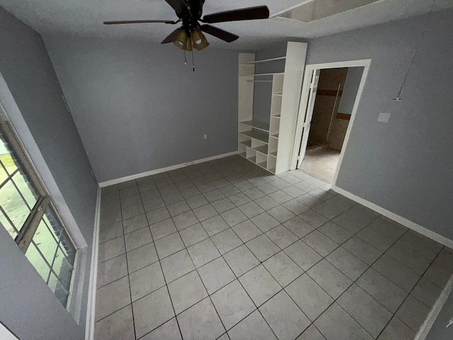 unfurnished room featuring ceiling fan and light tile patterned flooring