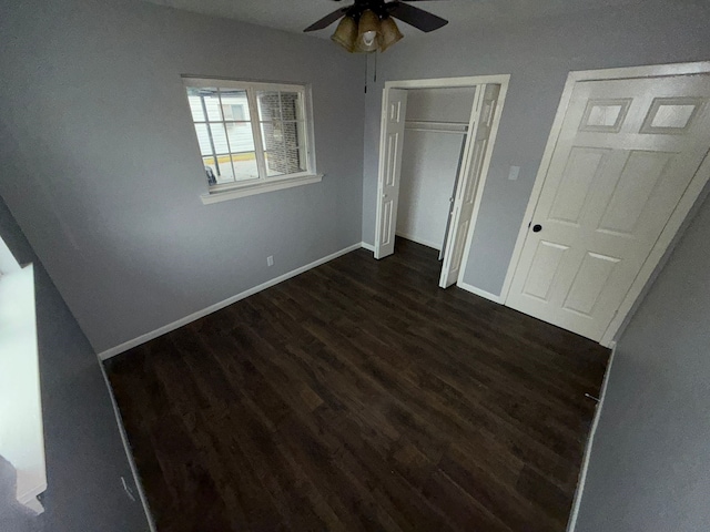 unfurnished bedroom featuring a closet, ceiling fan, and dark wood-type flooring