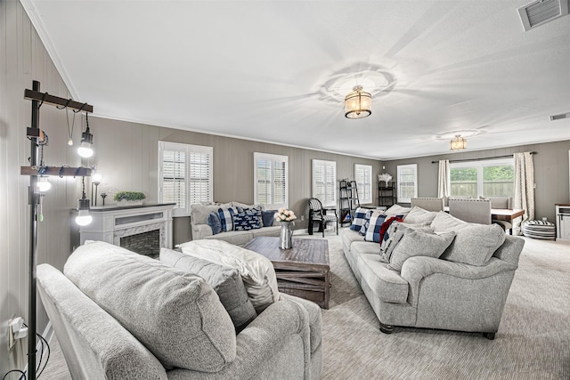 living room featuring light carpet, ornamental molding, and a premium fireplace