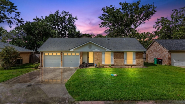 view of front of property featuring a yard and a garage