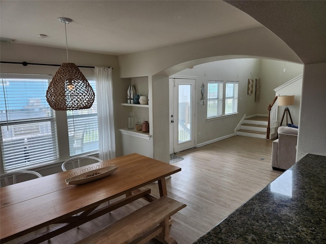 22901 Buena St, Galveston, TX 77554 - dining room with built in shelves, a textured ceiling, and light hardwood / wood-style flooring