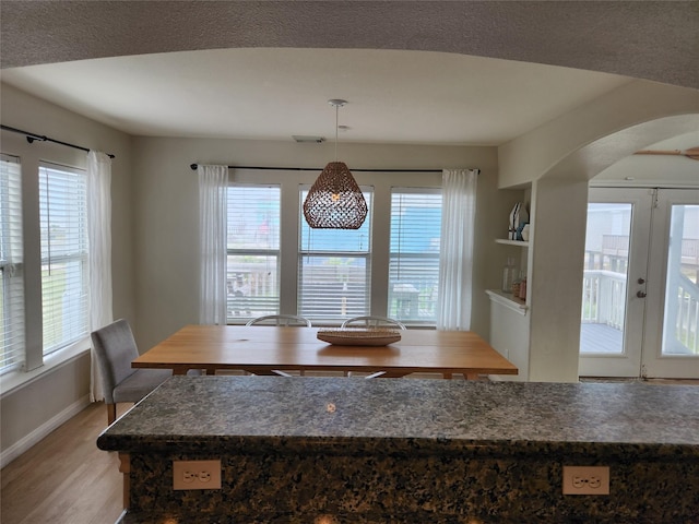 22901 Buena St, Galveston, TX 77554 - unfurnished dining area with french doors, a healthy amount of sunlight, and light wood-type flooring