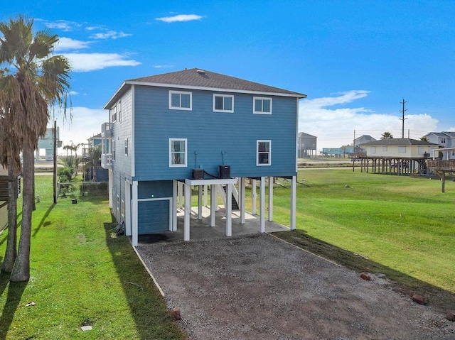 22901 Buena St, Galveston, TX 77554 - back of house with a carport and a lawn