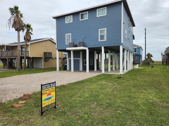 22901 Buena St, Galveston, TX 77554 - rear view of property featuring central AC, a yard, and a carport