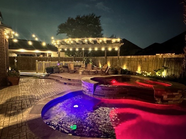 pool at twilight with a patio area