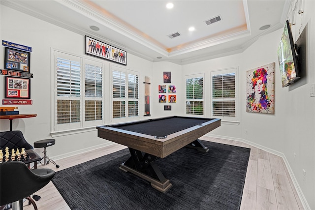 recreation room with crown molding, pool table, light wood-type flooring, and a tray ceiling